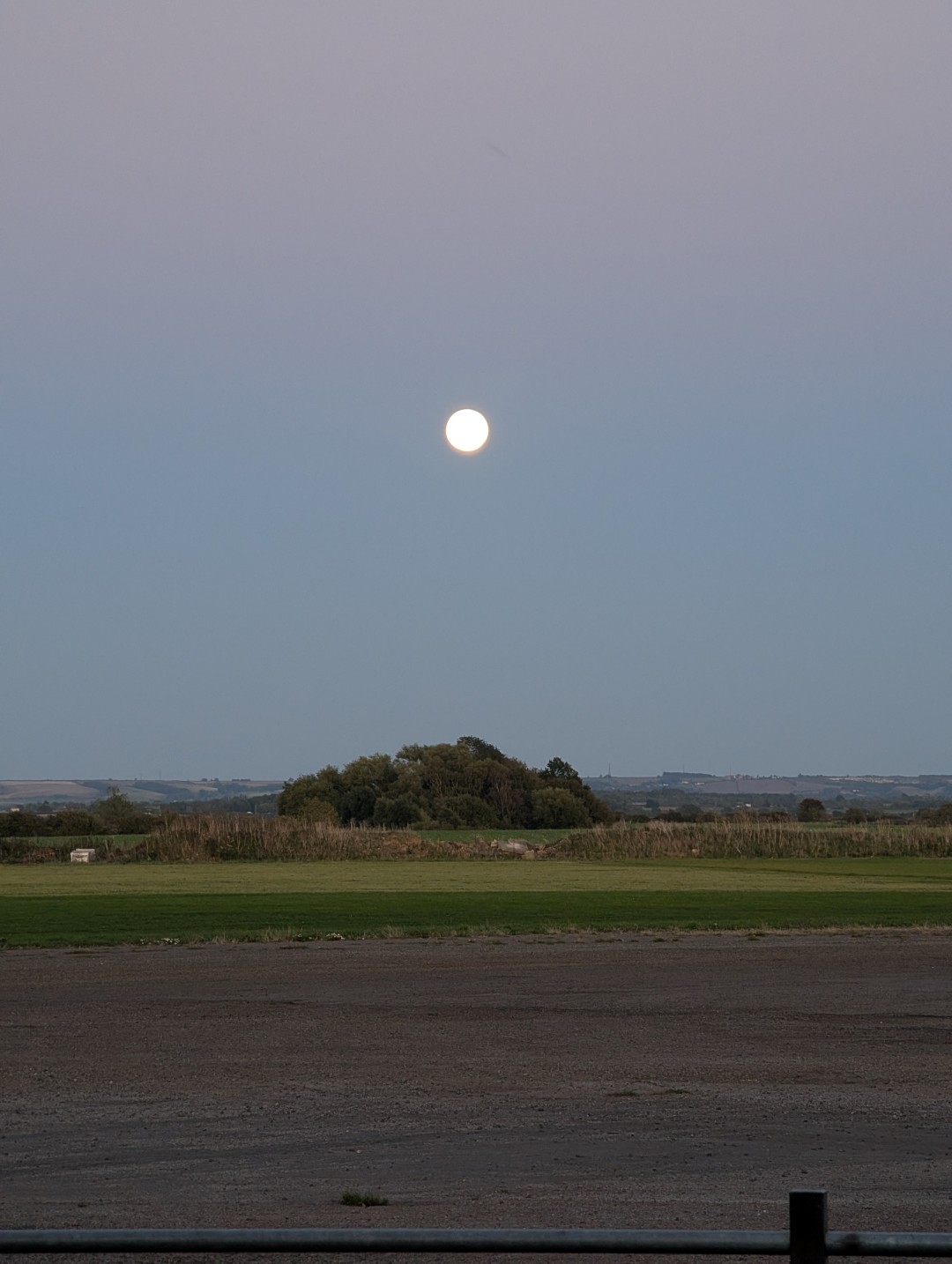the moon over an airfield
